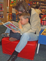Photo of a mum reading to her child