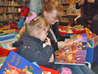 Photo of a mum reading a story to her child