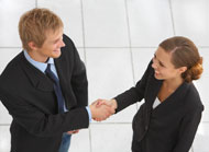 A photo of a man and a woman shaking hands