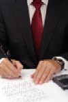 A photo of a man writing notes