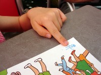 a photo of a child looking at a workbook
